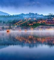 Tourists take a boat at Ban Rak Thai village in Mae Hong Son province, Thailand.